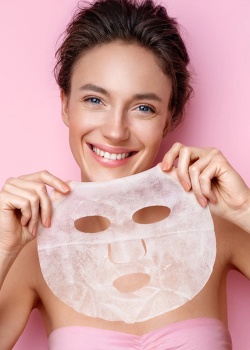 Girl holding a hydrating facial mask as part of a Nainital skincare routine