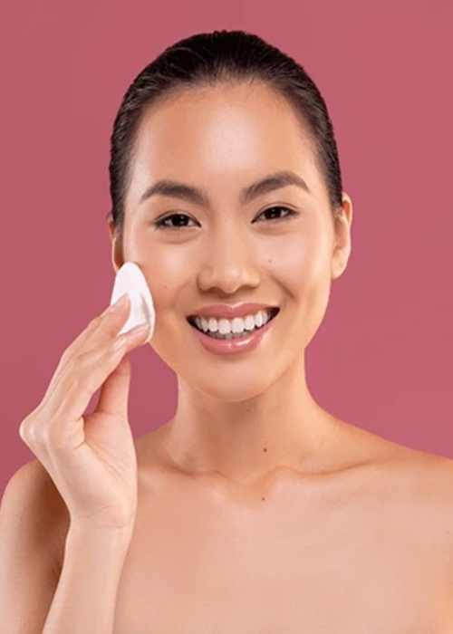 Applying toner as part of a natural Nainital skincare routine